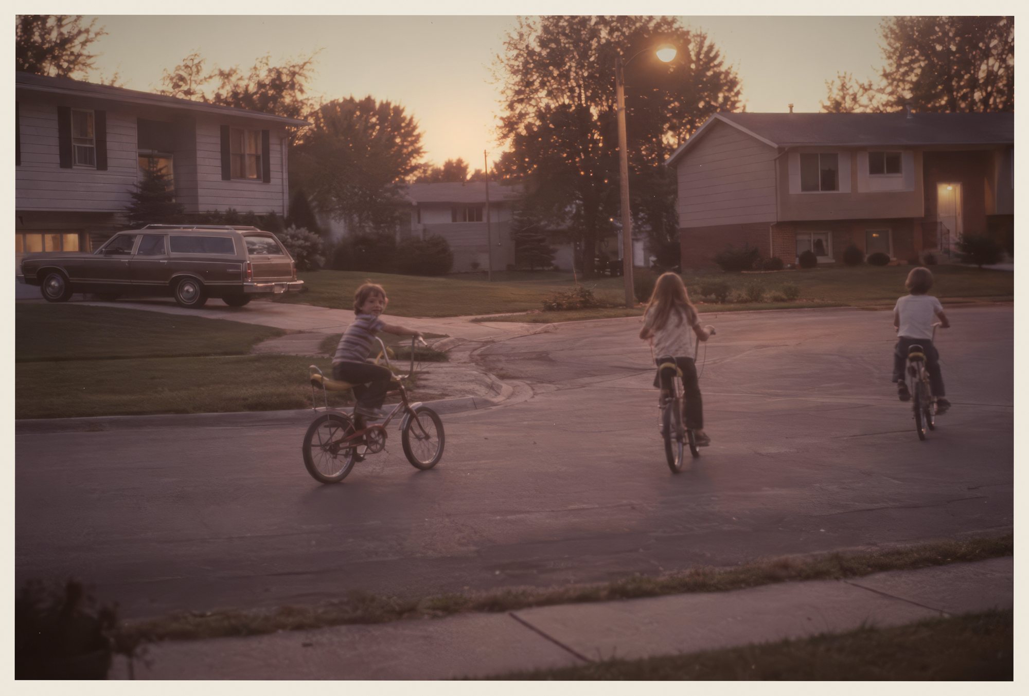 Kids on bikes at dusk on a cul-de-sac